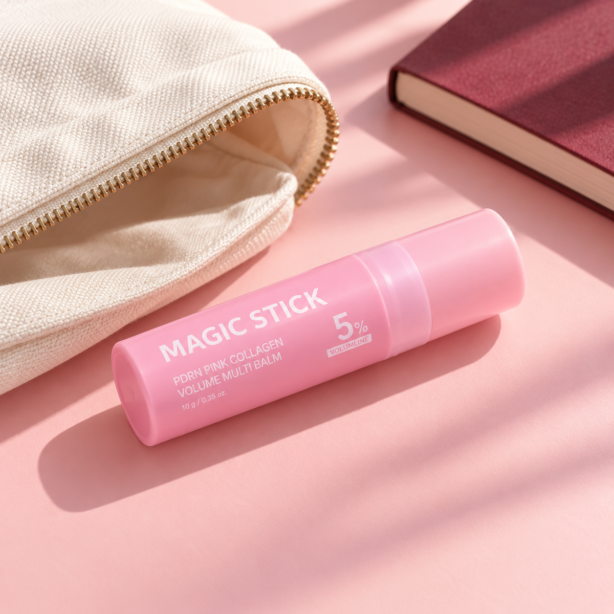 Pink balm stick beside an everyday pouch.